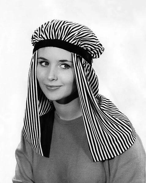 Reveille fashion. Ann Cave wearing arab style head dress. December 1961 P006887