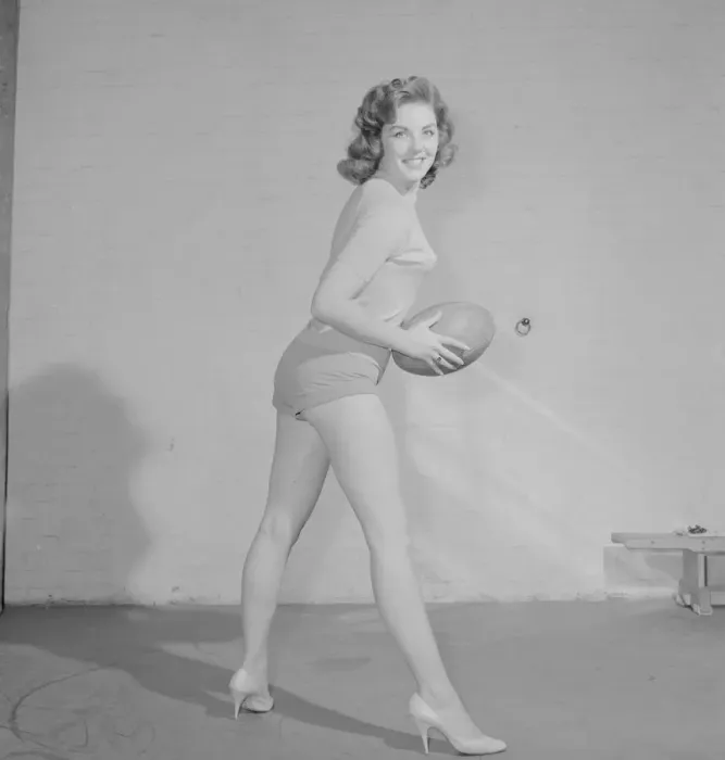 Framed Print : Reveille Fashion Feature The Vernon girls pose with rugby balls in the reveille