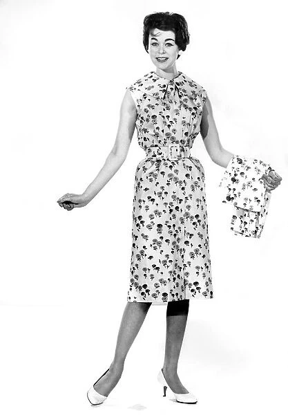 Reveille Fashion. Model wearing floral print summer dress May 1959 P006956