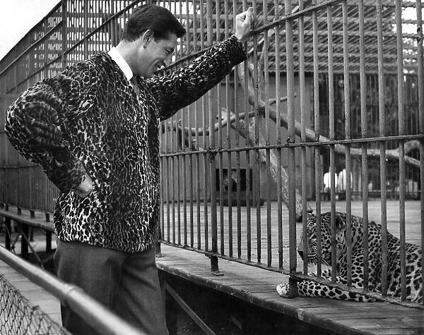 Reveille Fashions 1961: Richard at Chessington Zoo wearing a leopard skin jacket poses