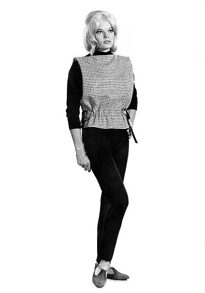 Reveille Fashions 1964: Dianna Terry modeling a bib top with black slacks