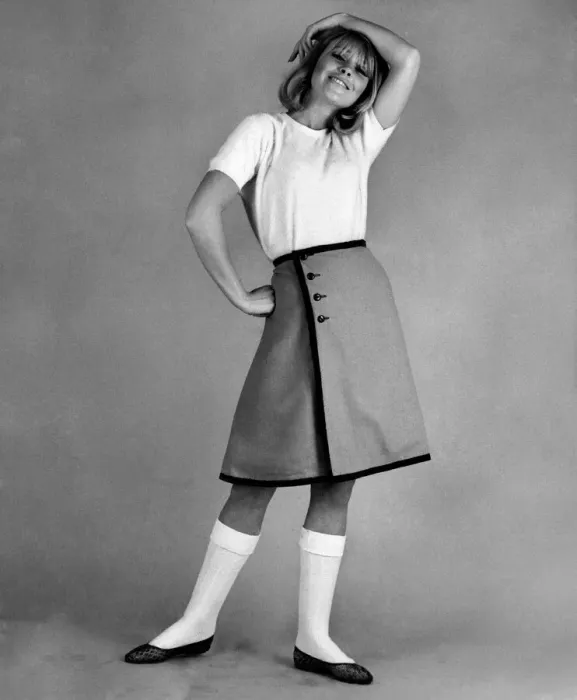 Framed Print : Reveille Fashions 1965: Marilyn Rickards modeling a white t-shirt and knee length skirt