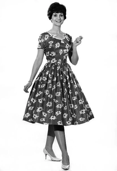 Reveille fashions: Ann Cave modelling a flower print summer dress. July 1961 P008773