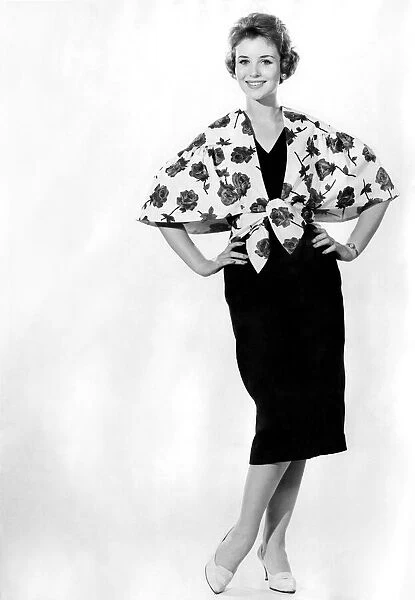 Reveille fashions: Ann Cave modelling a rose print shawl over over a dress February