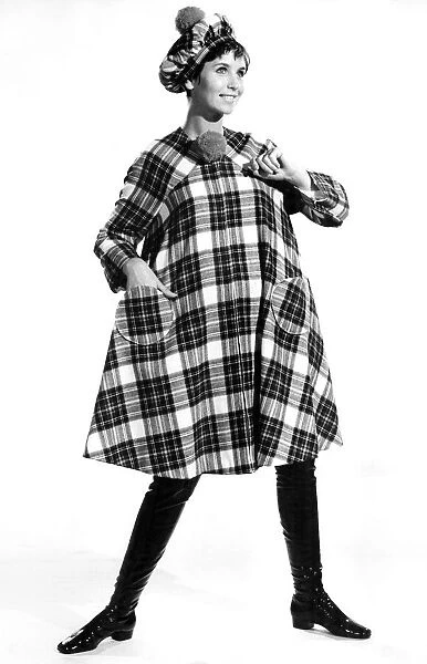 Reveille Fashions: Ann Cave modelling tartan hat and poncho. September 1967 P006700