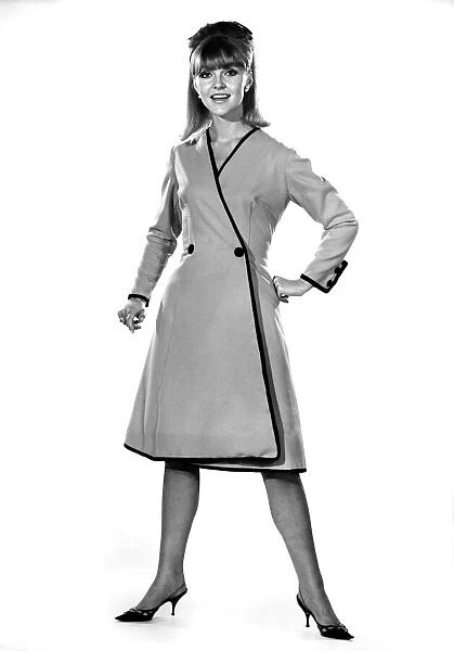 Reveille Fashions: Ann Roberts modeling a double breasted coat. September 1964 P007596