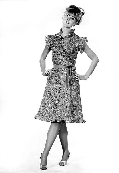 Reveille Fashions: Ann Roberts modeling a leaf pattern dress with matching belt