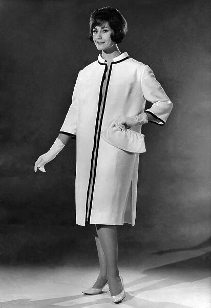 Reveille Fashions: Geraldine Hill modeling a elegant white evening coat with matching