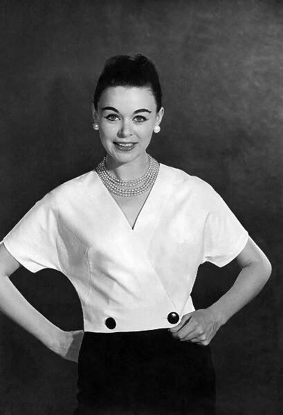 Reveille Fashions: Jackie Jackson modelling a wrap over blouse. October 1959 P006982