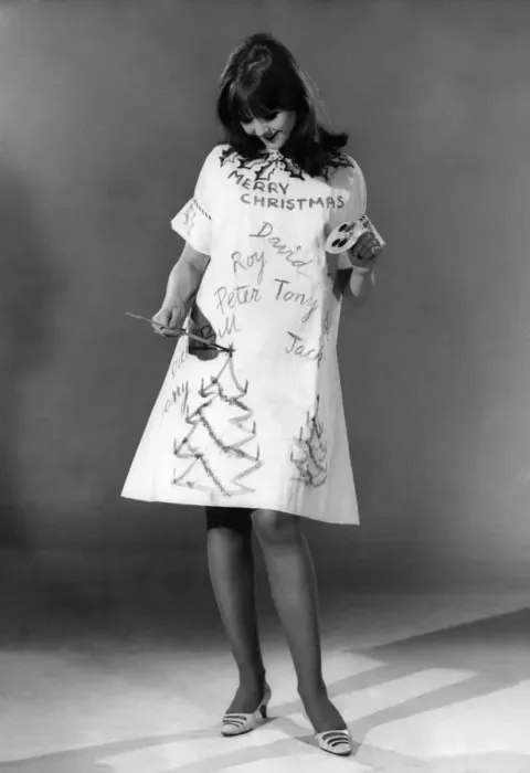 Framed Print : Reveille Fashions: Joanne Young decorating her own christmas dress. December 1966 P006647 Framed Print : Reveille Fashions: Joanne Young decorating her own christmas dress. December 1966 P006647