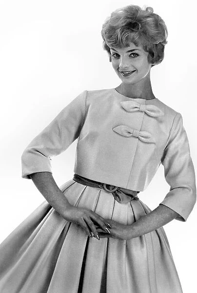 Reveille Fashions. Mannequin modeling a bow blouse jacket and pleated skirt