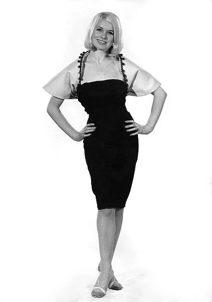 Reveille Fashions Mannequin modeling tailored evening dress. November 1964 P007586