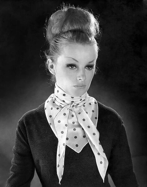 Reveille Fashions. Mannequinn modeling a scarf tied into a bow. January 1964 P007615