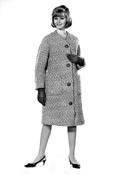 Reveille Fashions: Margaret Lorraine modeling a winter coat. August 1964 P007536