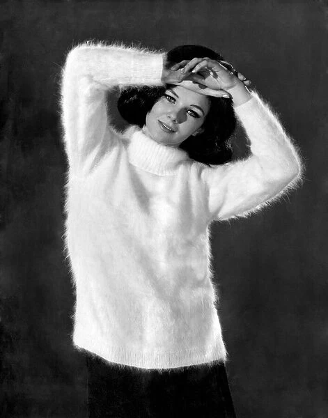 Reveille Fashions. Meriel Weston wearing white jumper. October 1964 P007535