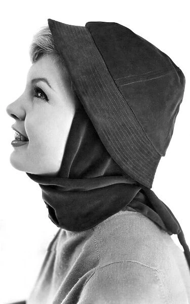 Reveille Fashions. Model wearing hat and scarf January 1959 P006940