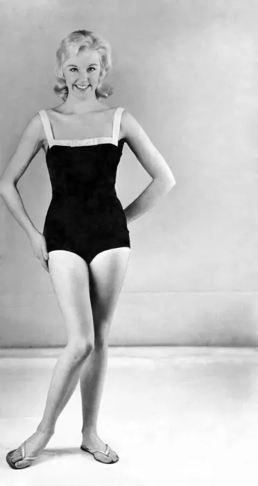 Framed Print : Reveille Fashions. Model wearing a one piece swimming costume and flip flop shoes Framed Print : Reveille Fashions. Model wearing a one piece swimming costume and flip flop shoes