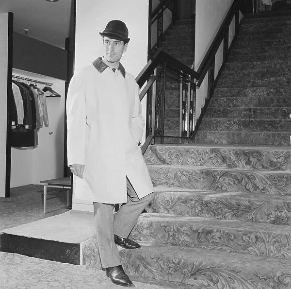 Reveille Mens Fashions of the Future shoot. Man wearing raincoat and hat on stairs