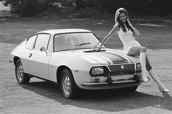 Reveille model Beulah Hughes seen here posing with a Lancia car which is a top prize in