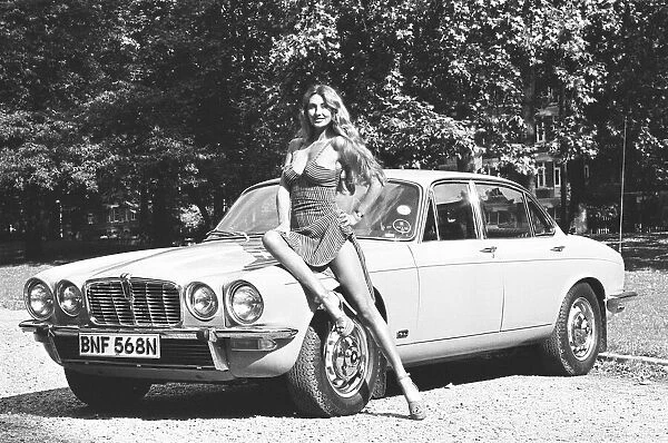 Reveille model Marilyn Coles seen here posing with a Jaguar