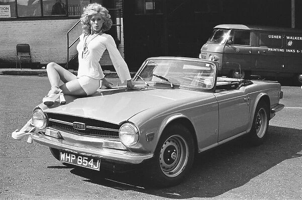 Reveille model Nicky Howarth seen here posing with a TR6 car which is top prize in