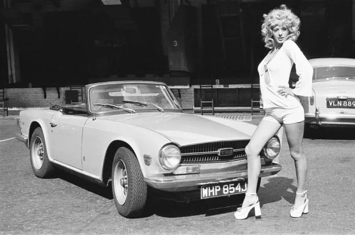Framed Print : Reveille model Nicky Howarth seen here posing with a TR6 car which is top prize in Framed Print : Reveille model Nicky Howarth seen here posing with a TR6 car which is top prize in