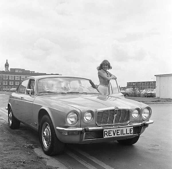 Reveille model seen here posing with a Jaguar XJ12, which is first prize in a Reveille
