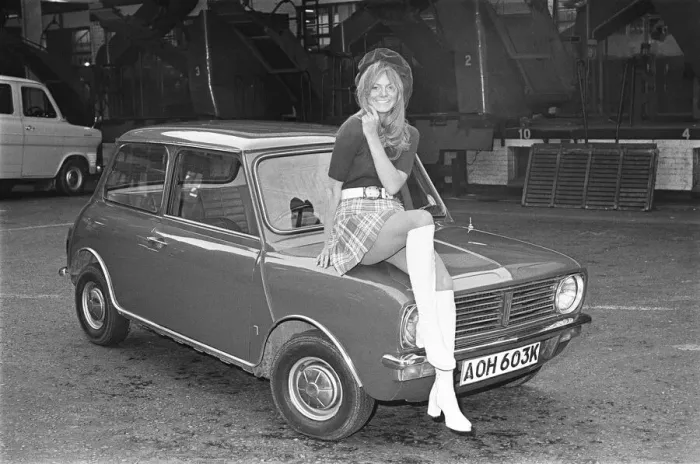 Framed Print : Reveille model seen here posing with a Mini Clubman car which is a top prize in Framed Print : Reveille model seen here posing with a Mini Clubman car which is a top prize in