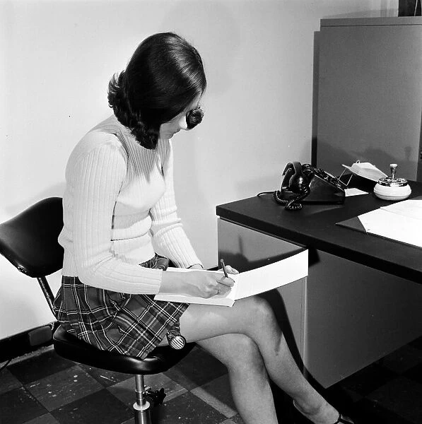 Reveille Studio Model posing as a secretary with a garter watch strapped to her thigh