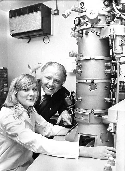 Richard Attenborough looks at an electron microscope with Junior technicain Margaret Mole