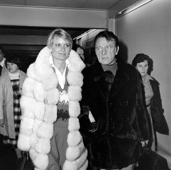 Richard Burton and his wife Susie at London Airport. December 1976