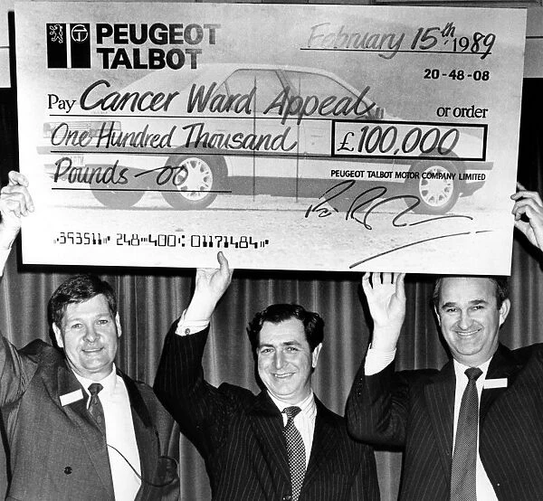 Richard Parham(right), assistant MD at Peugeot get help with the oversized cheque
