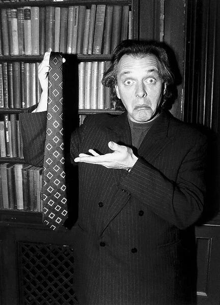 Rik Mayall holding up a tie Making a funny face January 1989
