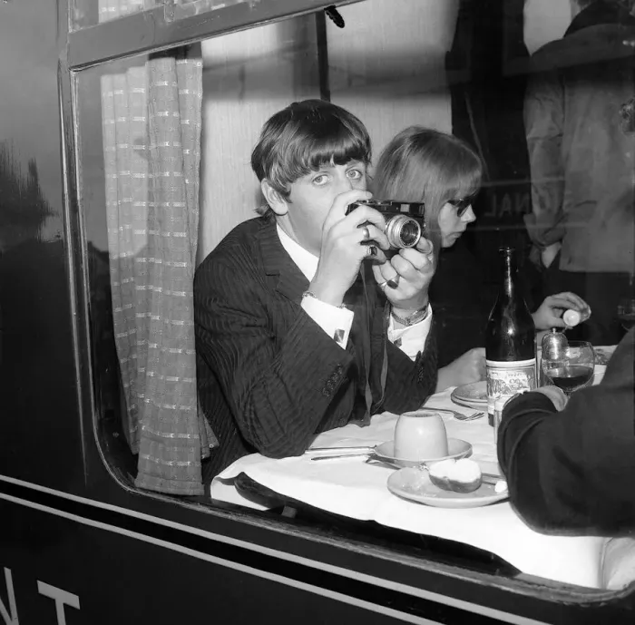 Framed Print : Ringo Starr with a cine camera and an actress in his compartment with the Beatles Framed Print : Ringo Starr with a cine camera and an actress in his compartment with the Beatles