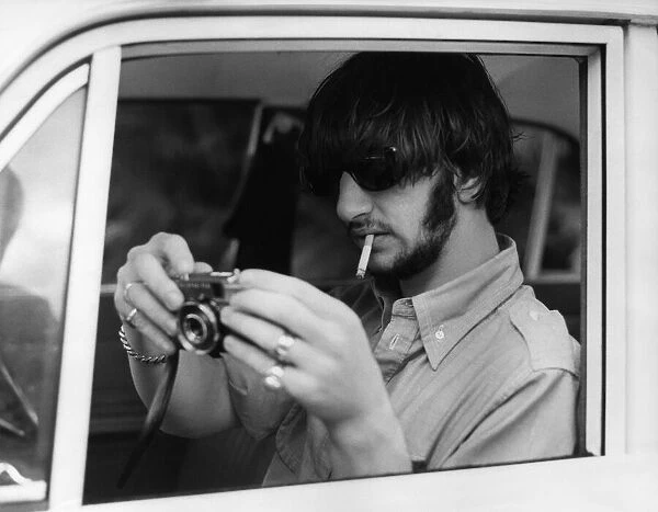 Ringo Starr drummer with The Beatles pictured with camera, on holiday in Tobago