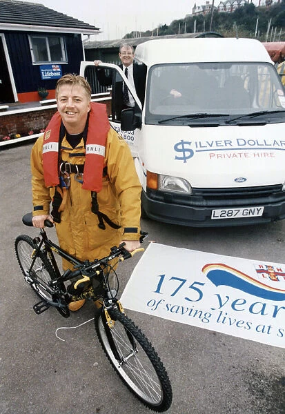 RNLI crew member with bicycle. Circa 1990s