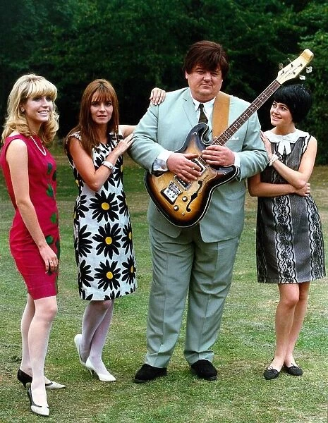 Robbie Coltrane actor standing with three women holding guitar