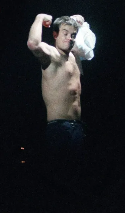 Framed Print : Robbie Williams in concert SECC Glasgow February 1999 takes of shirt shows off bare chest