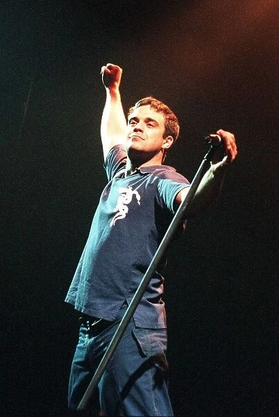 Robbie Williams concert SECC Glasgow February 1999 stretching holding microphone stand