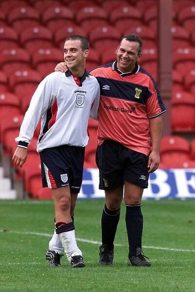 Robbie Williams playing football November 1999 wearing a England kit for the first half