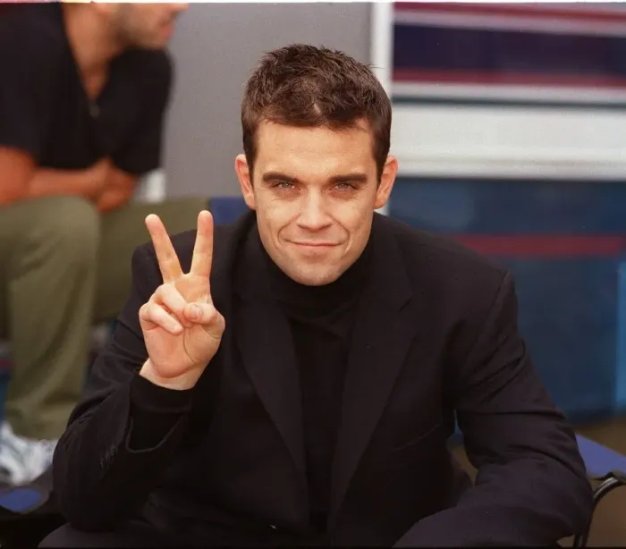 Framed Print : Robbie Williams relaxes on the set of his lastest video being shot in the grounds of Framed Print : Robbie Williams relaxes on the set of his lastest video being shot in the grounds of