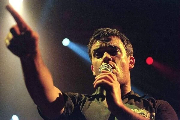 Robbie Williams sings at his concert at the SECC Glasgow February 1999