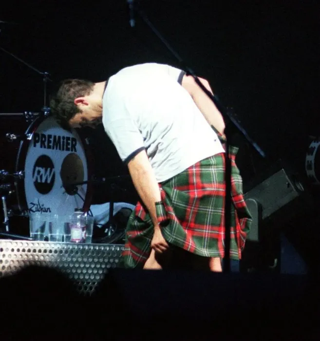 Framed Print : Robbie Williams wearing kilt starting to pull it up February 1999 during SECC concert