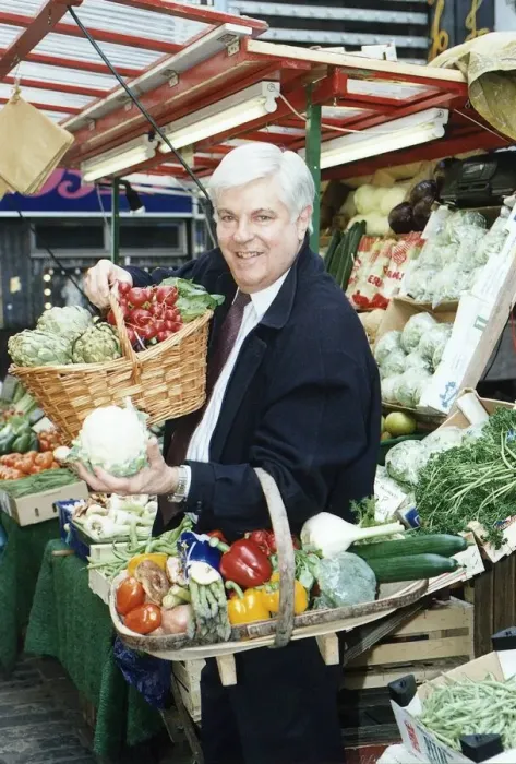 Framed Print : Robert Carrier TV chef Television Standing at a fruit stall Holding baskets of