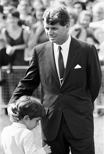 Robert Kennedy former Senator and brother of President John F Kennedy clasping the head