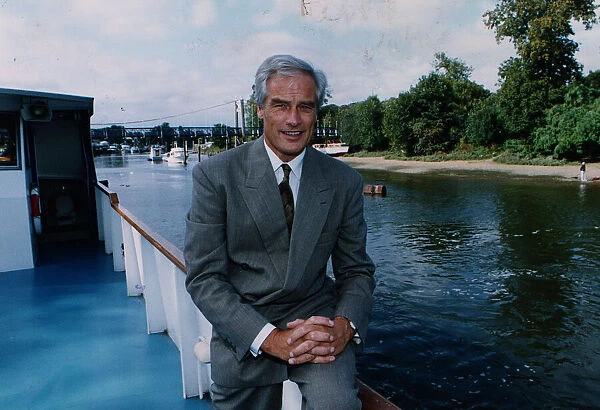Robert Kilroy Silk former MP - TV Presenter on boat beside river grey suit