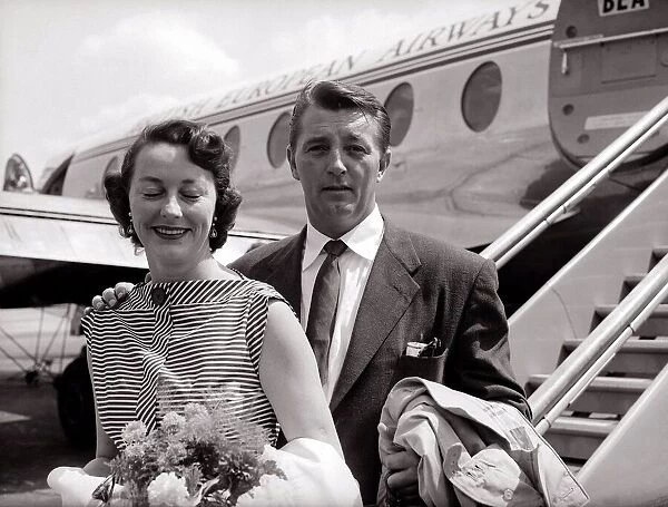 Robert Mitchum and his wife - July 1955 arrive at the London Airport