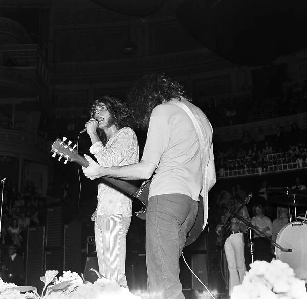 Robert Plant, lead singer of rock group Led Zeppelin, performing on stage during a
