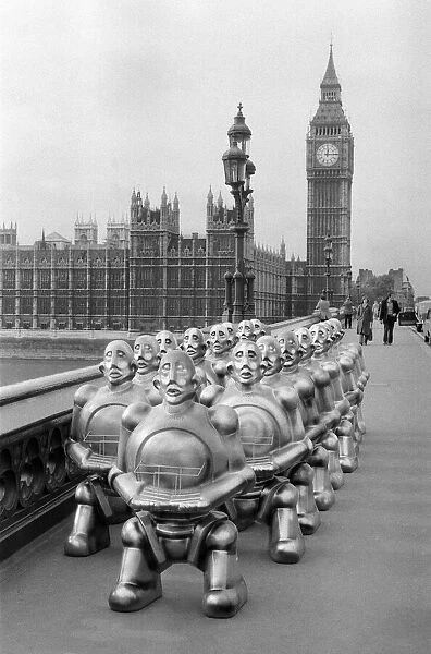 Robots lined up over Westminster Bridge. The robots were supplied by EMI Records who used