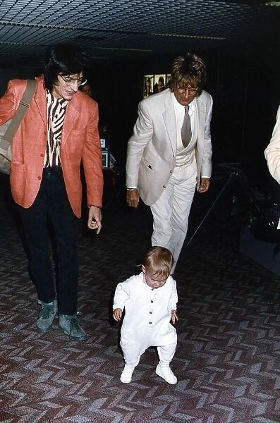 Rod Stewart singer songwriter with Ronnie Wood escorts baby daughter Renee through